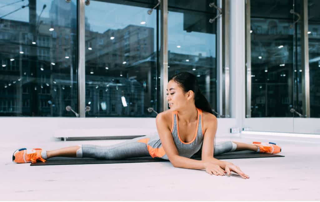 an Asian woman is stretching